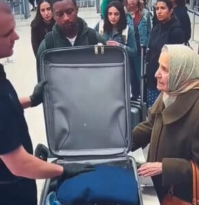During the baggage inspection of an elderly woman, the security officer noticed something strange on